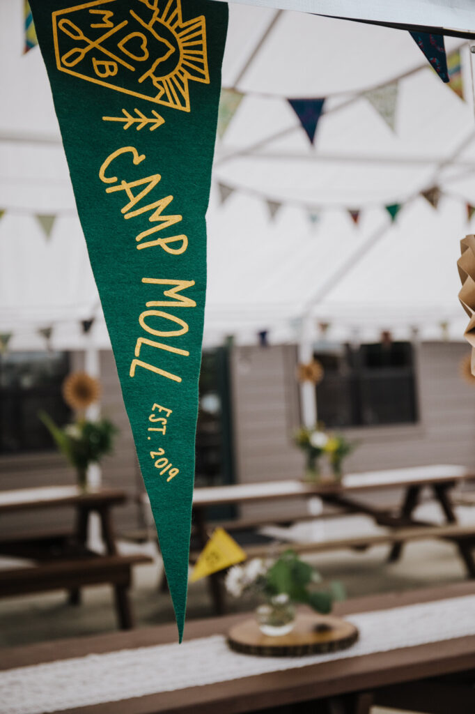 A custom green pennant designed for a campground wedding