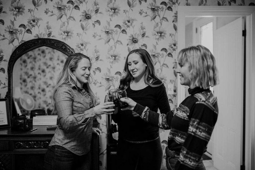 A bride and her bridesmaids toast before they start getting ready