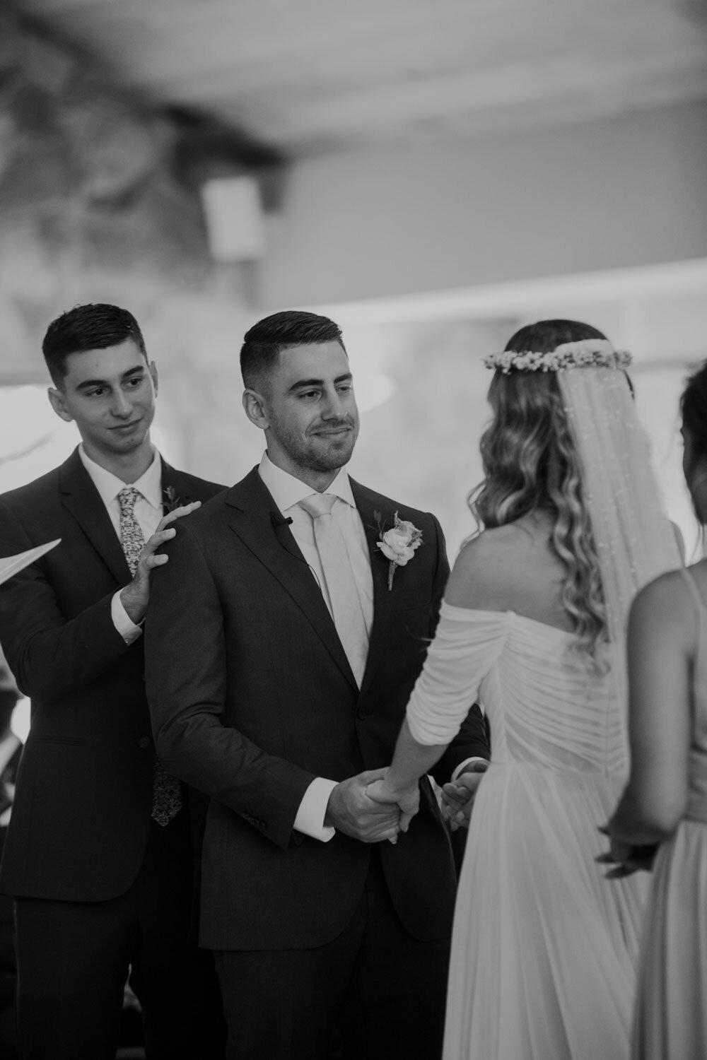 a groom looking serious while he says his vows