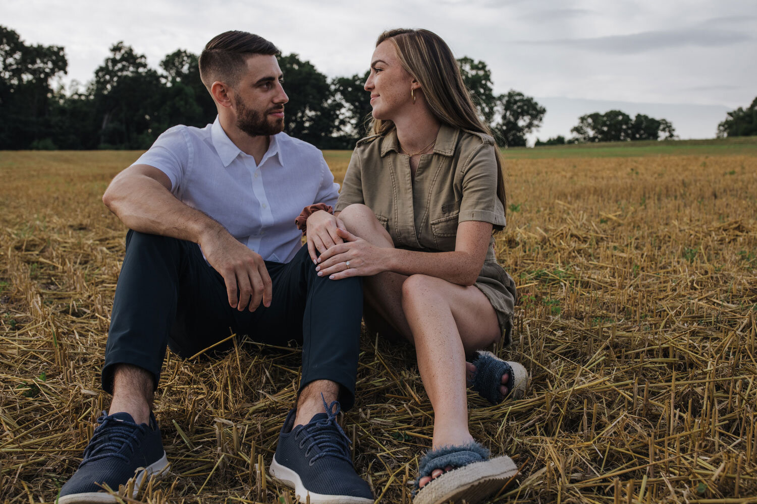 A couple sitting in a field in the Lehigh Valley