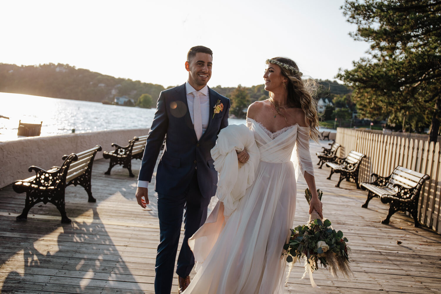 A portrait of the bride and groom on the boardwalk at the Lake Mohawk Country Club