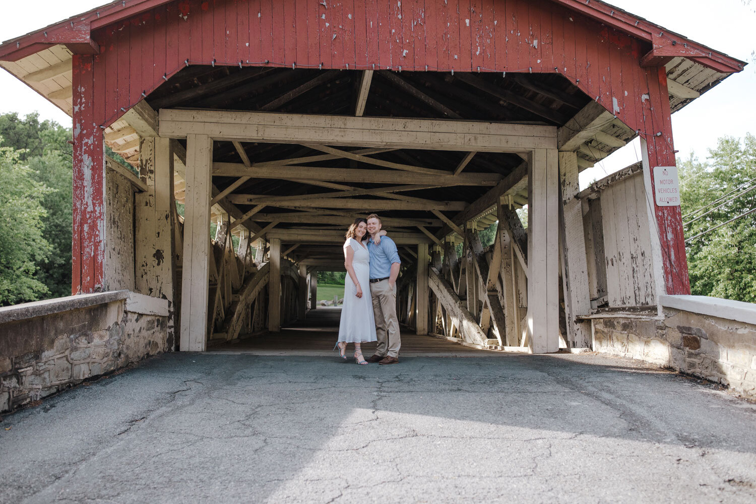 a couple in fron of a covered bridge on the lehigh valley parkway