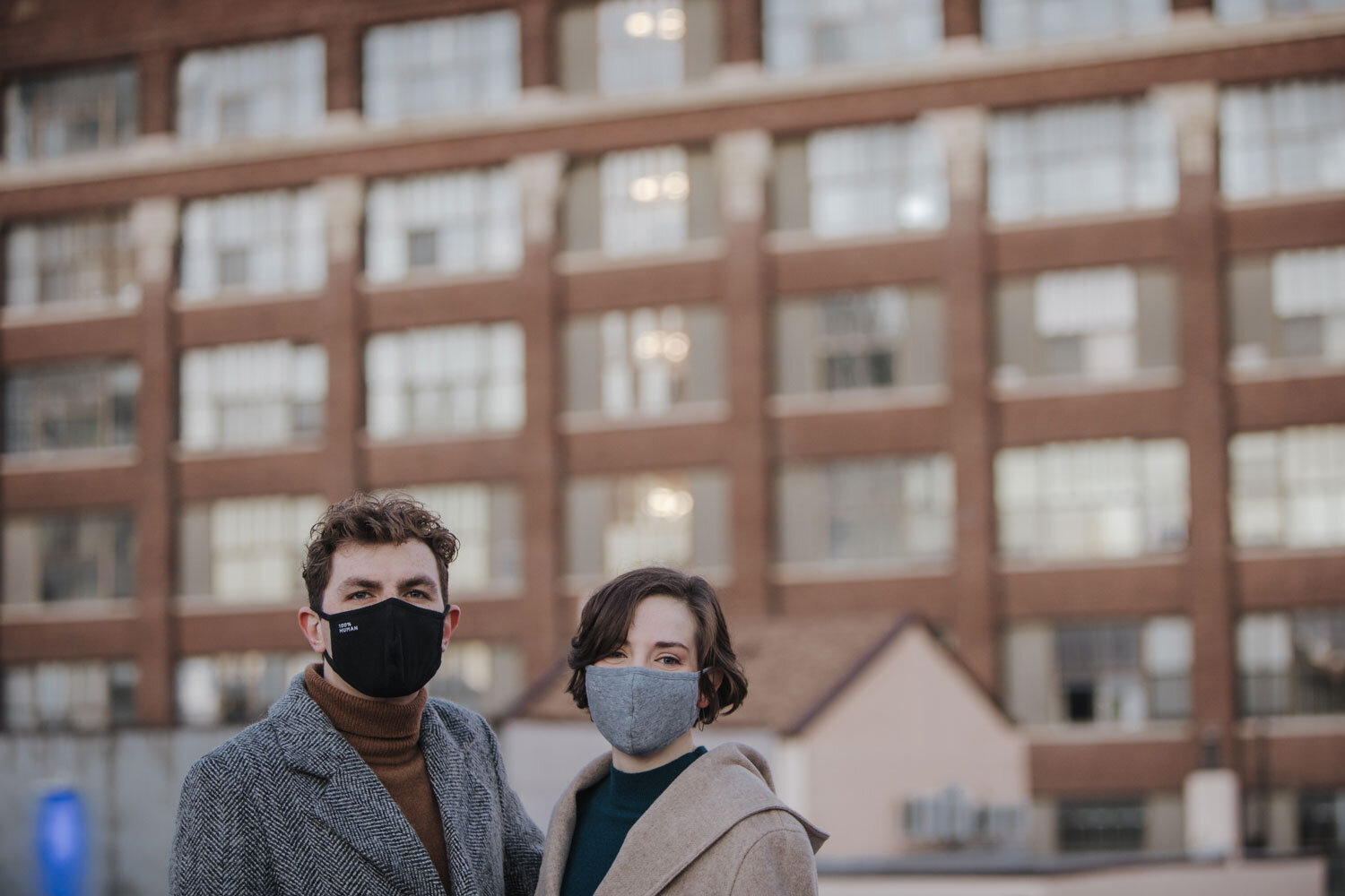 An engaged couple wearing masks in PHiladelphia
