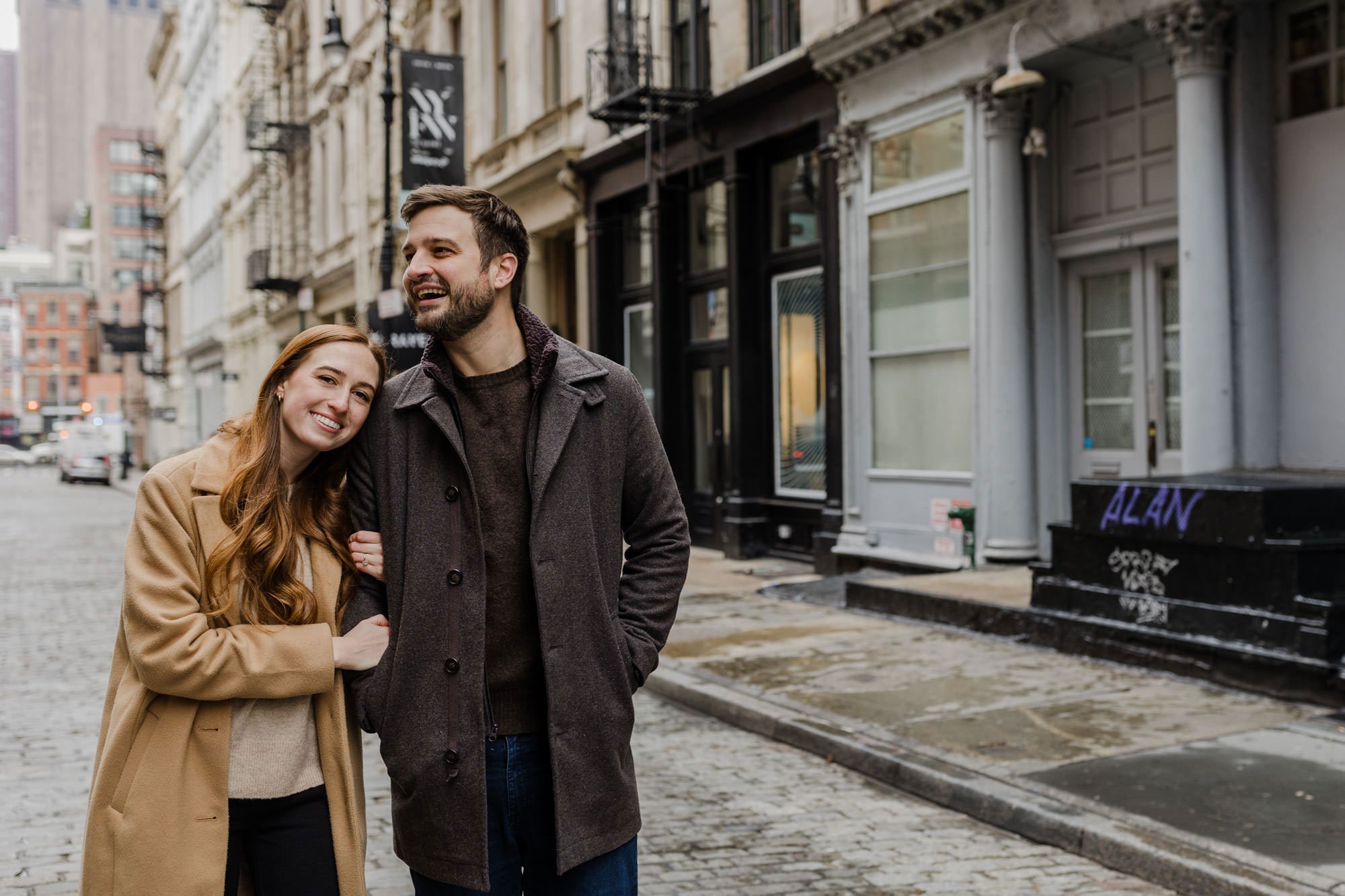 An engaged couple  standing on the street in SOHO in New York City
