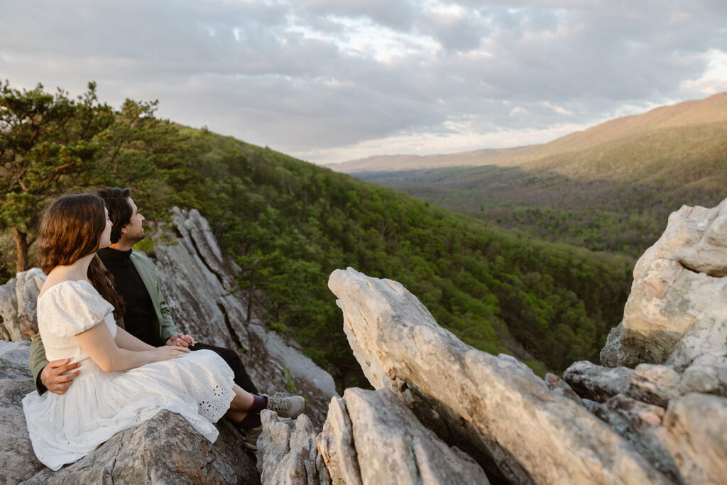 an eloping couple sits and enjoys a sunrise view during their elopement