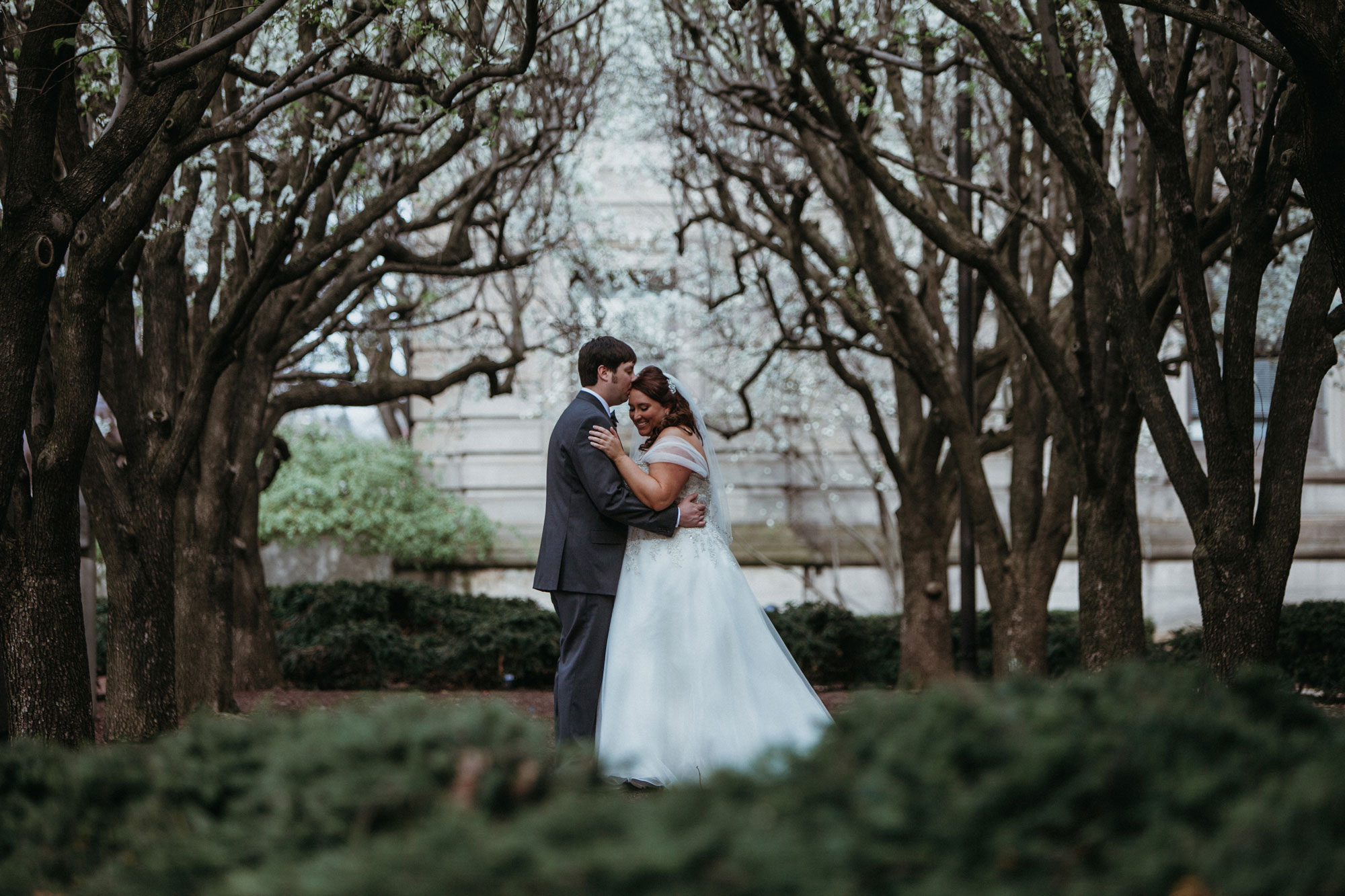 A bride and groom on the grounds of the Carnegie Museum of Natural History