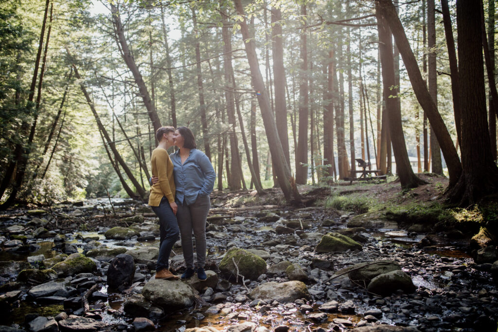 same sex couple hugging in the PA woods