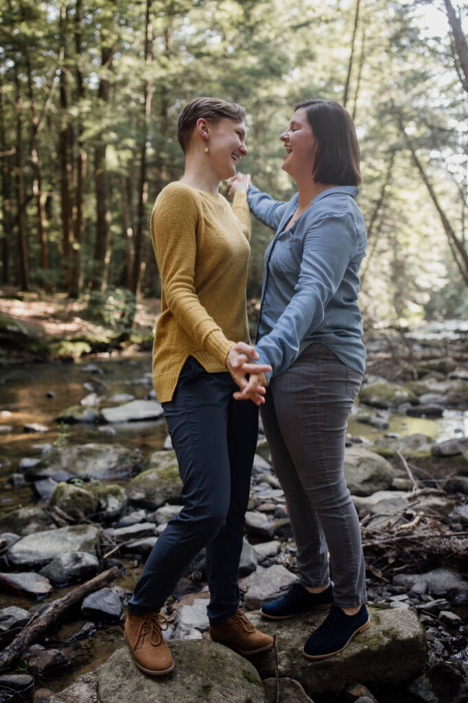 same sex couple laughing durning their engagement session
