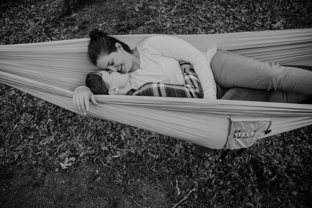 couple snuggling in a hammock while camping