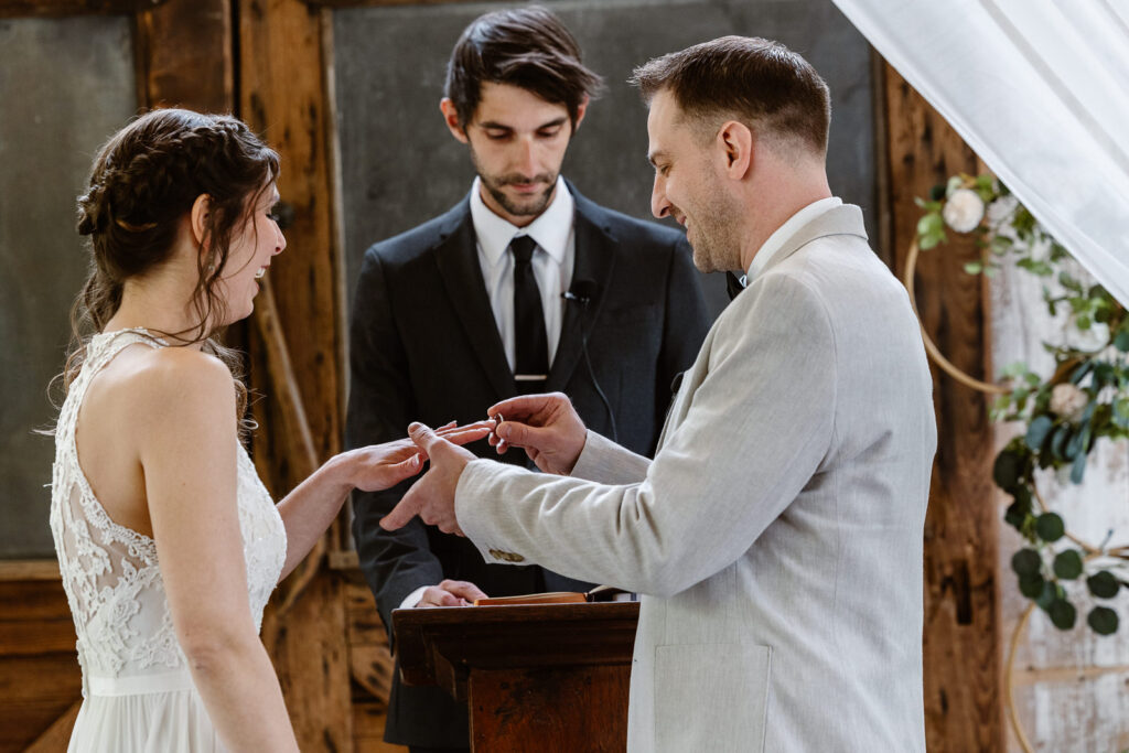 Groom putting a ring on his brides finger during their elopement ceremony