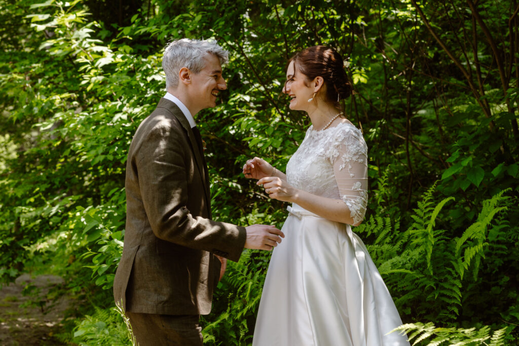 The bride and groom see each other for the first time on their wedding day at Drumore Mill. The bride’s delicate lace dress and the groom’s formal attire contrast against the greenery capturing a beautiful blend of elegance and rustic charm.