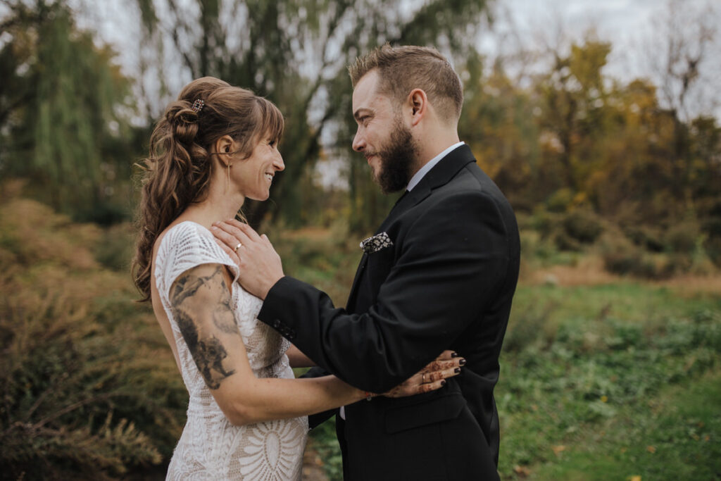 A couple reaching towards each other as they smile