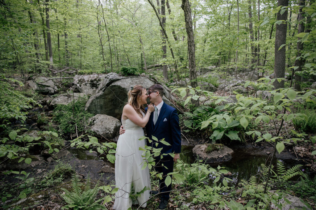 Newlyweds with their arms around each other about to kiss 