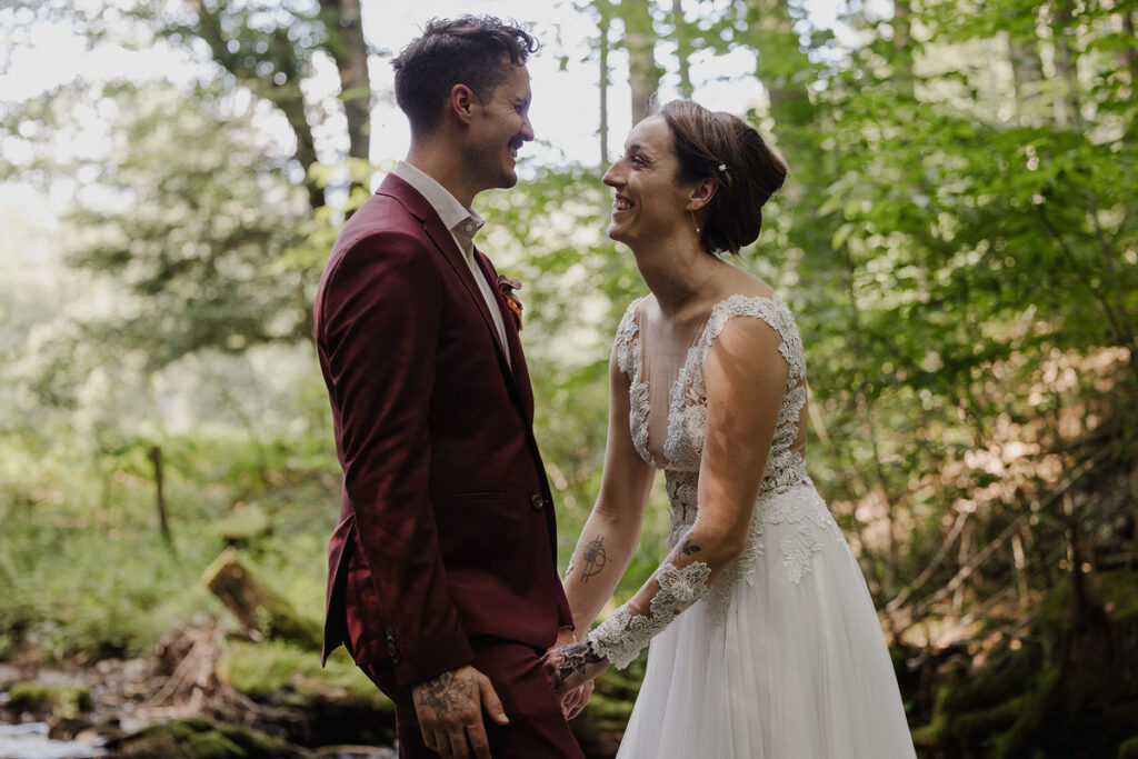 Newlyweds laughing together in the forest 