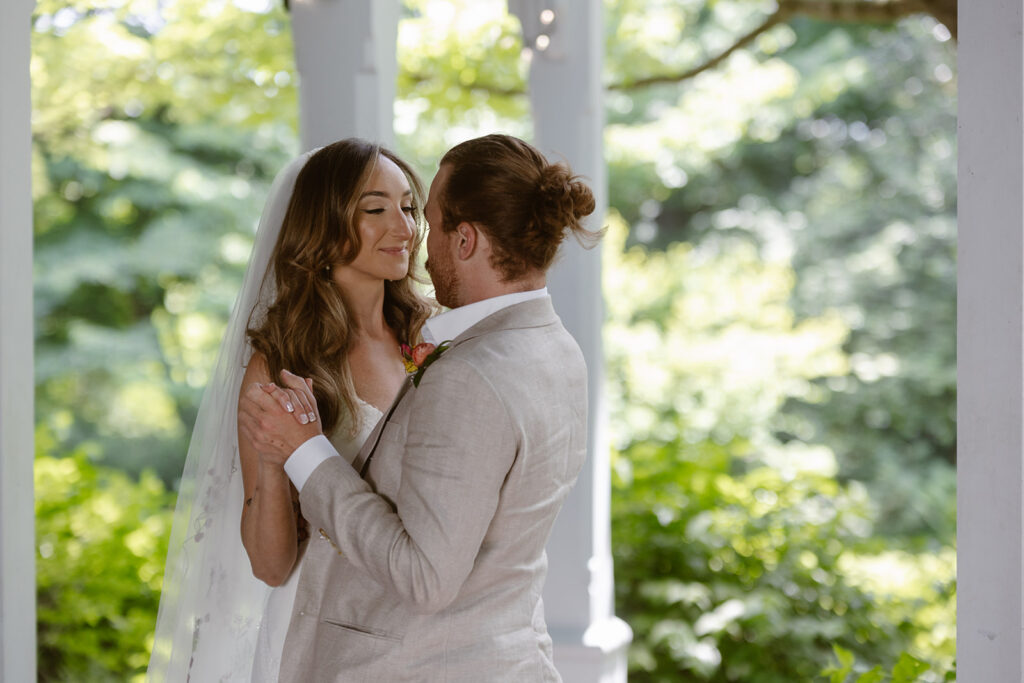 A bride and groom embracing during their private vow reading. 