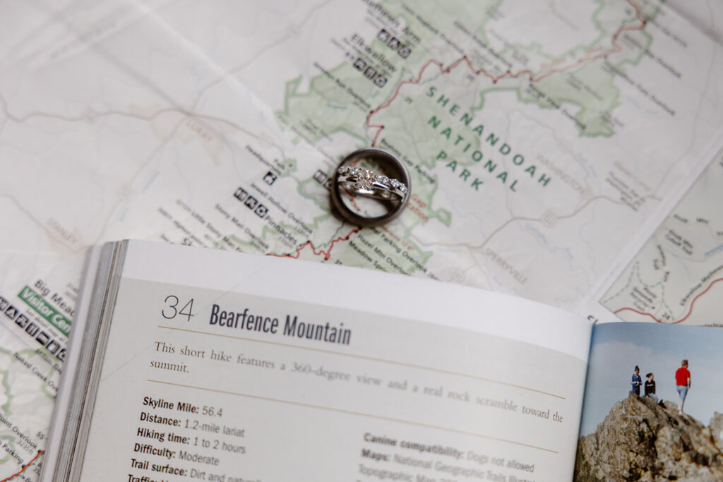 A detail photo of a bride and grooms rings, and a map of Shenandoah National Park. 