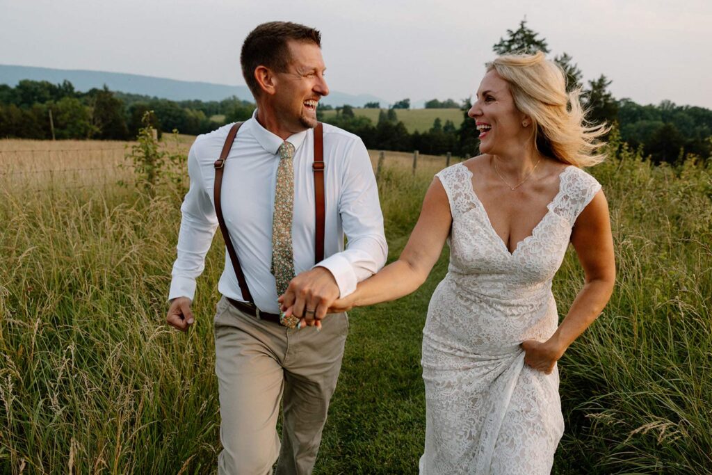 A couple running and smiling during their adventure elopement in Virginia