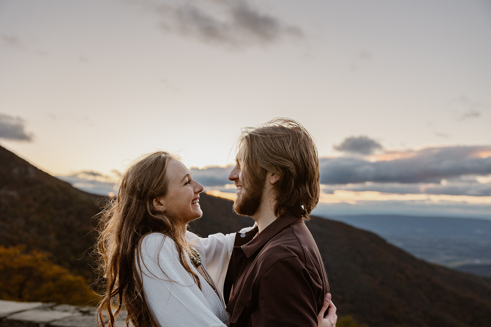 A bride and groom looking at each other and smiling during their elopement. 