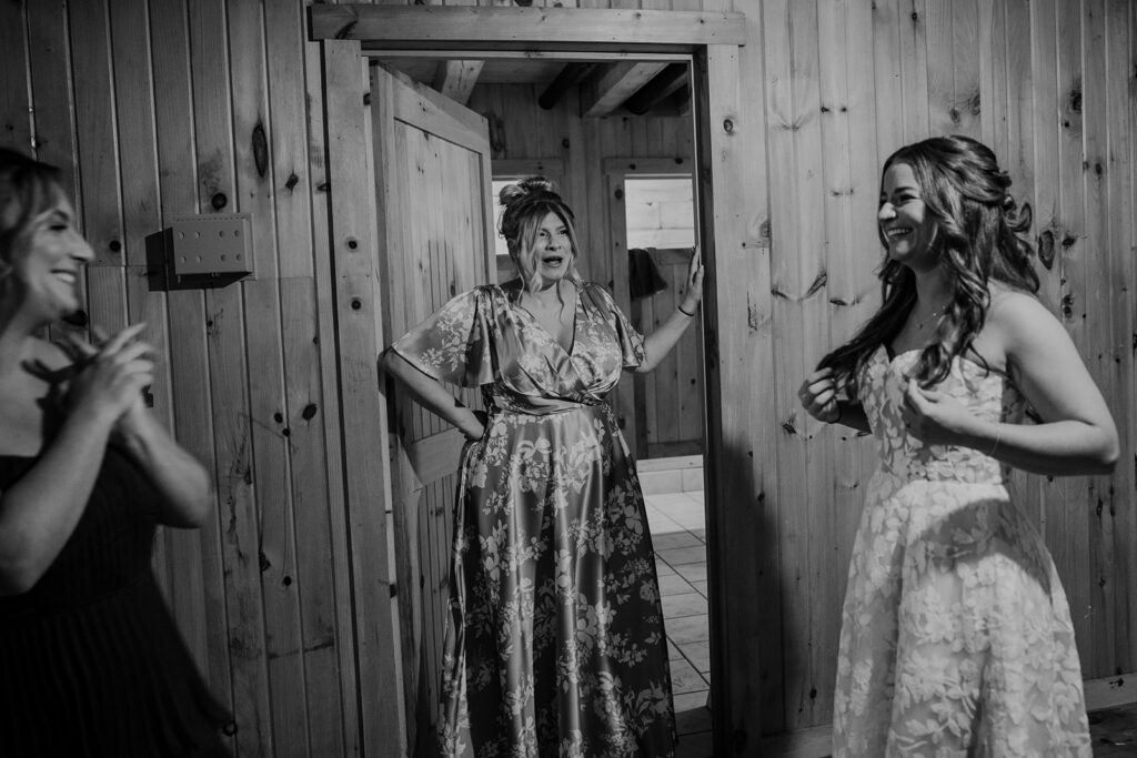 A black and white photo of the bride getting ready with her best friends