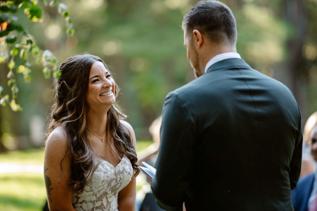 a man reading his vows to his partner who is wearing a white wedding dress