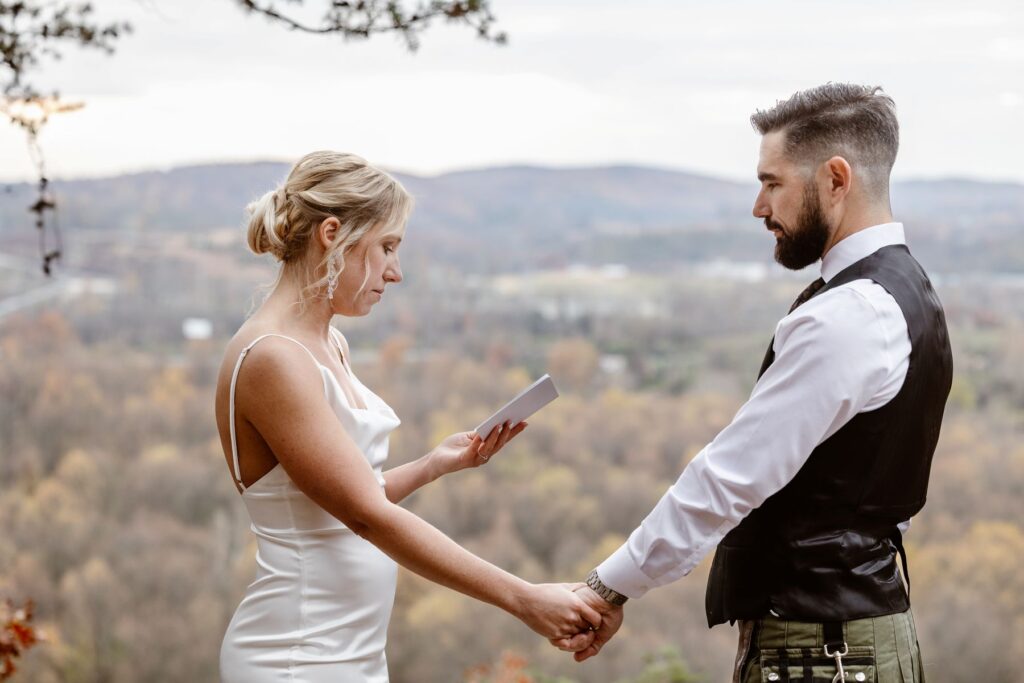A bride and groom exchange emotional vows on their wedding day. Their are mountains in the background. how to legally get married in pennsylvania