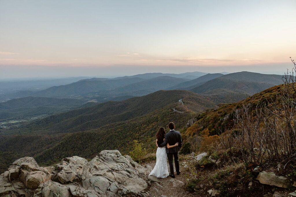 A couple admire the views of the Allegheny Mountains in Shenandoah National Park in Virginia