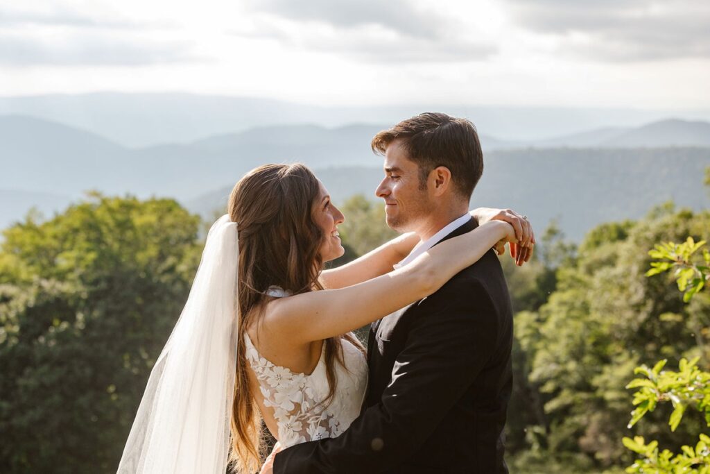 A couple embraces at an overlook on their elopement day