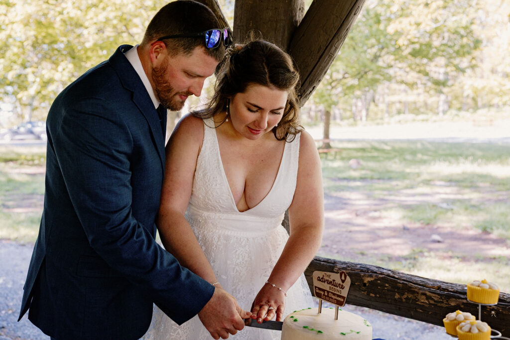 A bride and groom cut their cake on their wedding day during a casual brunch