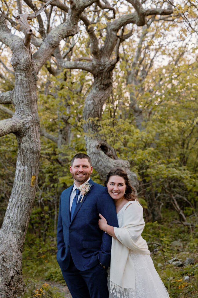 A portrait of a bride and groom in a lush Shenandoah forest