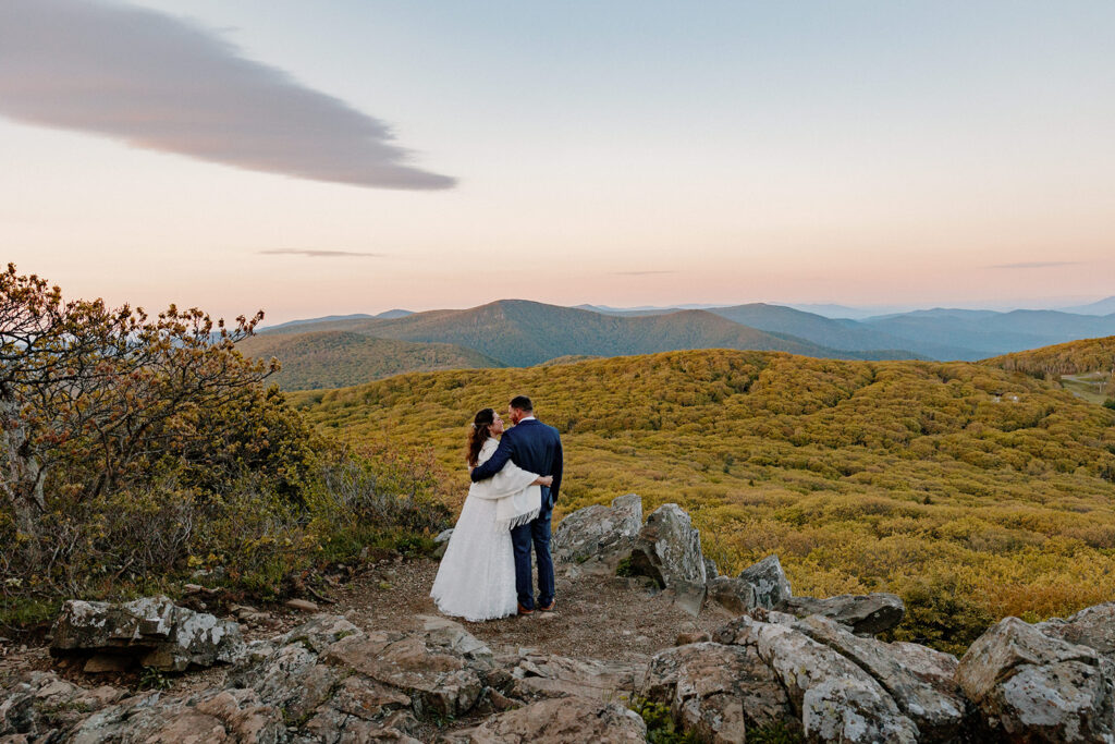 A bride and groom embrace and smiling, as they try to process the excitement of just getting married