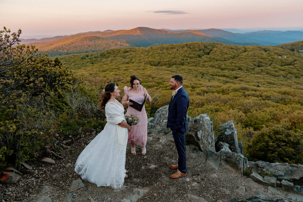 A couple stands at Stony Man Summit during their sunrise elopement.