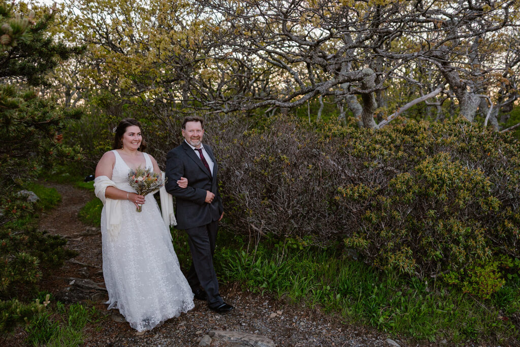 The father of the bride and bride walking to the overlook to begin the wedding ceremony