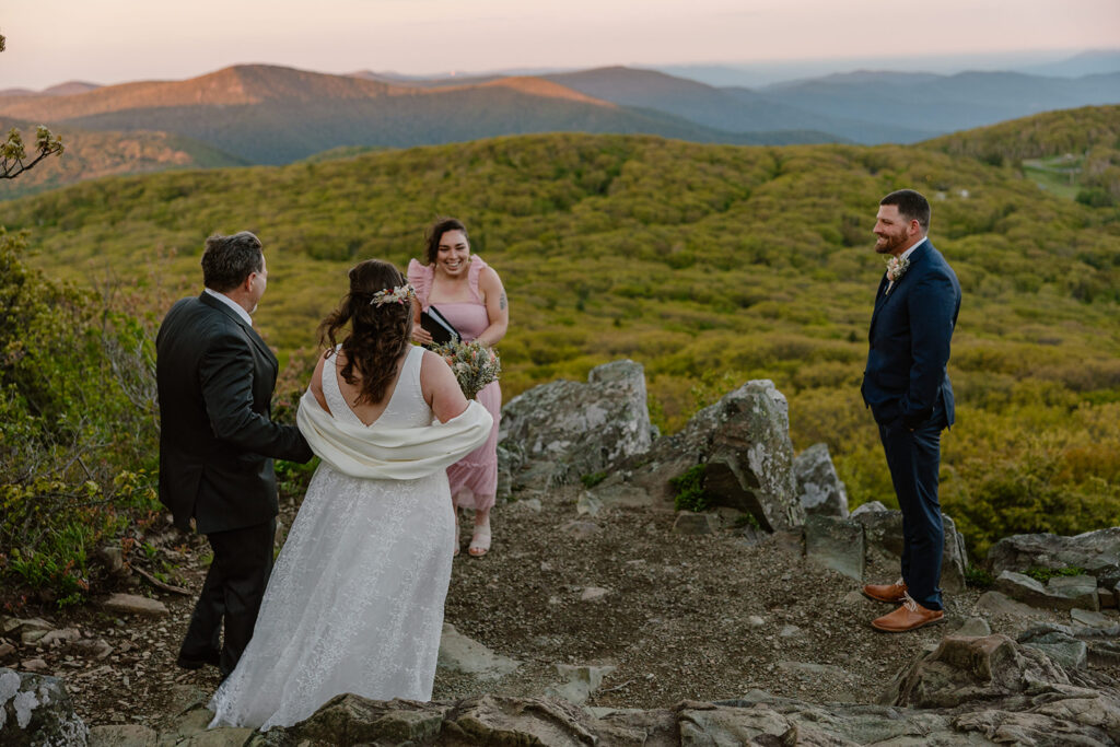 A bride and her dad walk towards the groom at the overlook at stony man summit