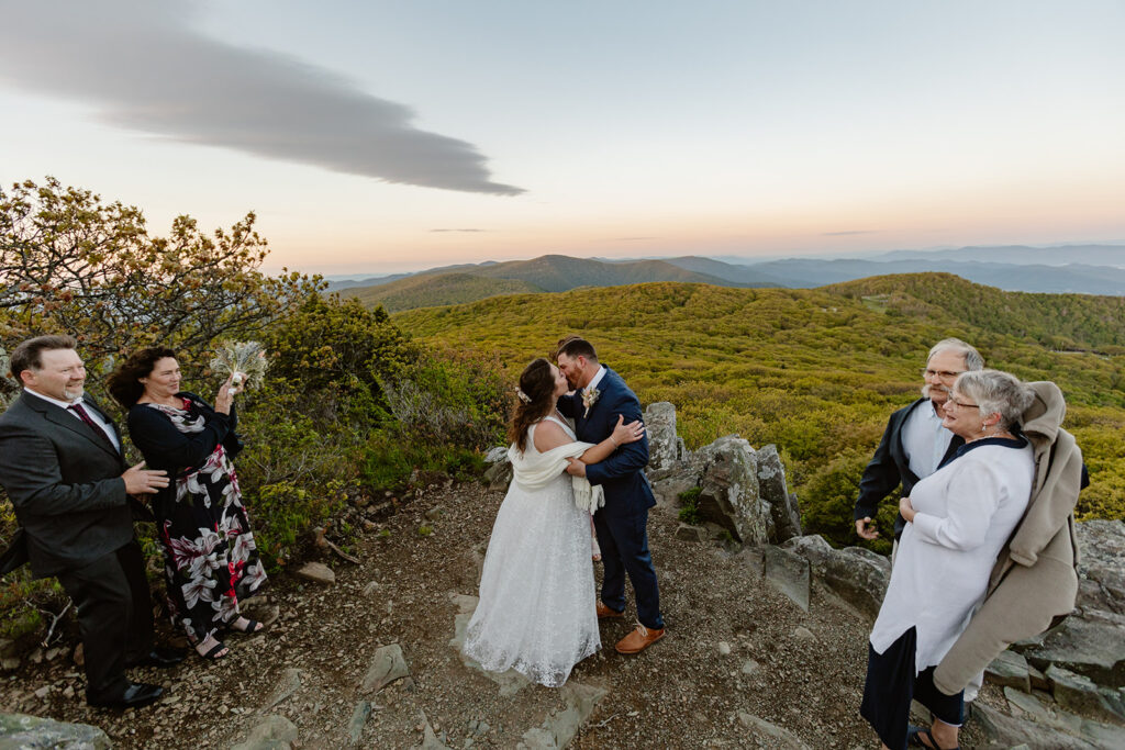 A bride and groom share their first kiss on their wedding day at the top of Stony Man