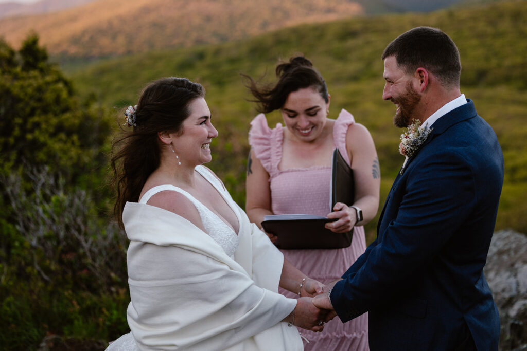 A bride and groom holding hands during their sunrise elopement at Stony Man in Shenandoah National Park