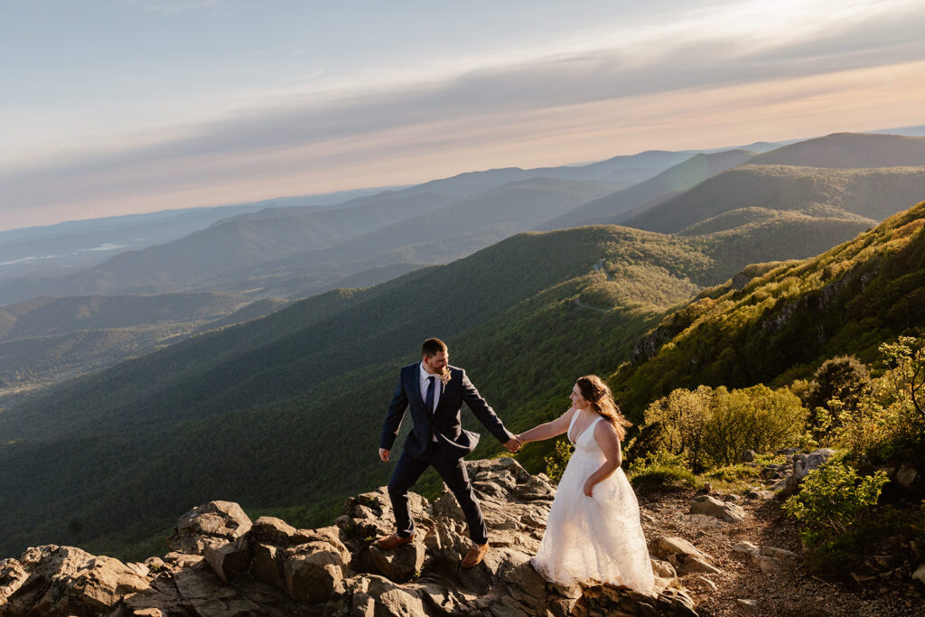 A couple on top of Stony Man Mountain during their sunrise elopement at Shenandoah National Park in Virginia