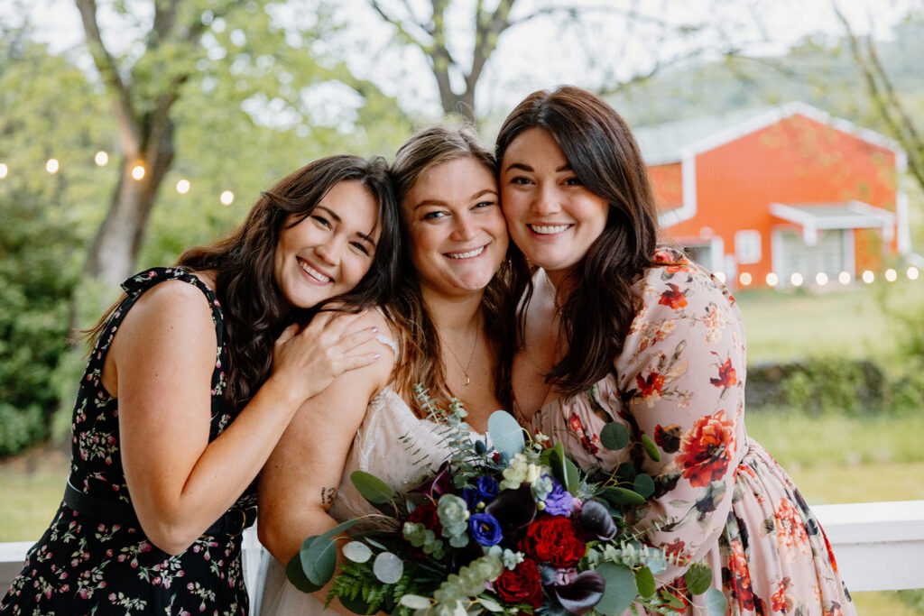 A bride and her two sisters pose during the reception