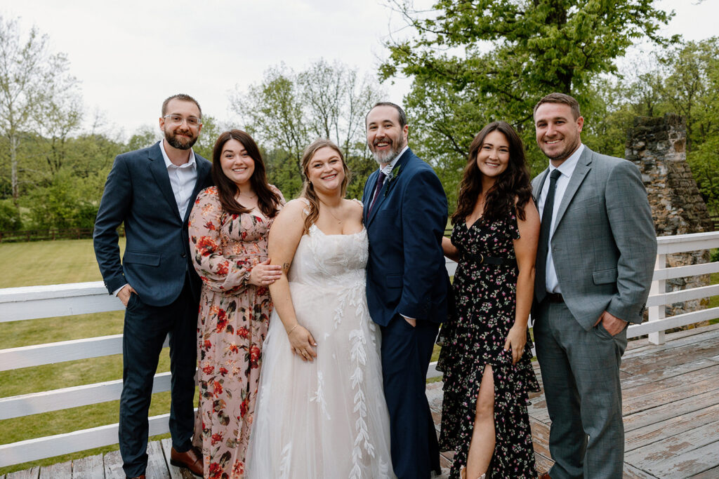 A group photo of the couple and some of their family members on their wedding day.