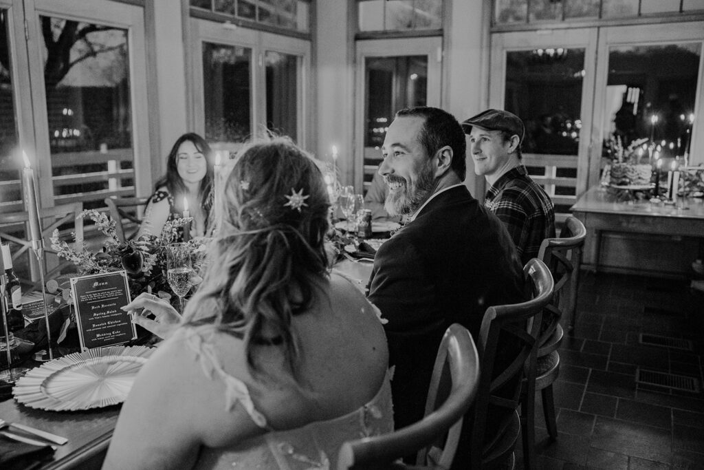 A bride, groom, and their immediate families sit at a table for an intimate reception to celebrate getting married. weddings in shenandoah national park