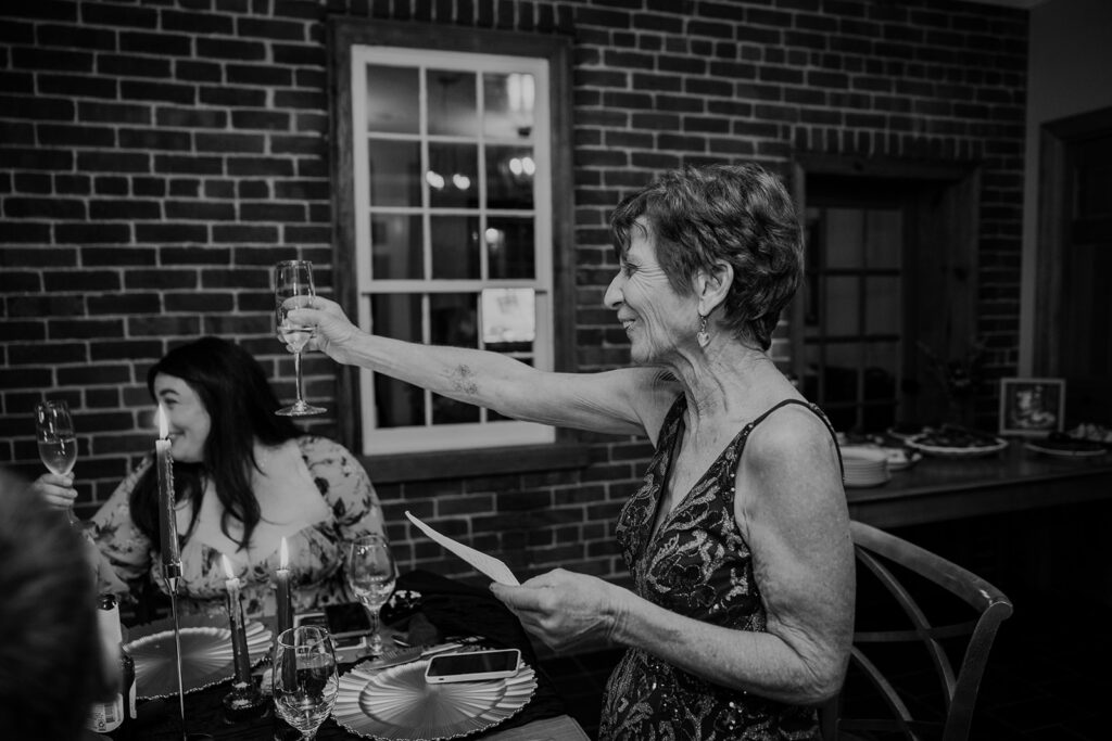 A photo of the mother of the bride giving a toast at the reception