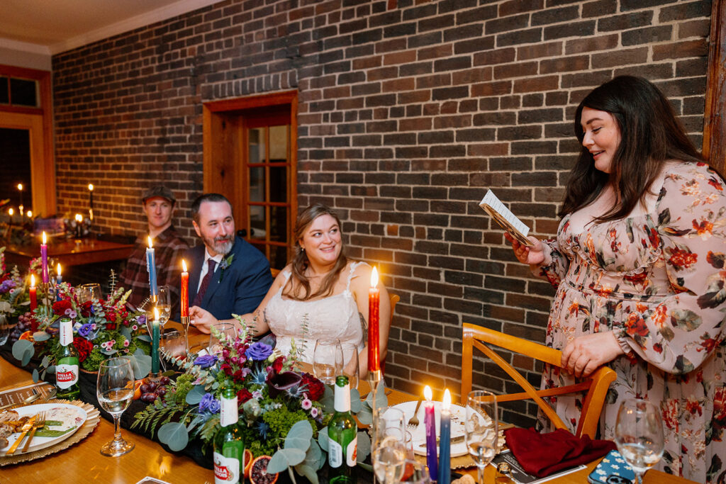 The sister of the bride reads a toast to the couple during the intimate reception.