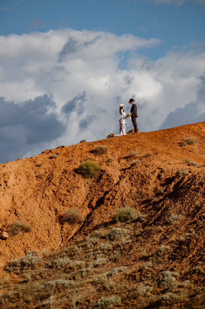 A bride and groom enchanting vows in the distance at Ida Gulch.