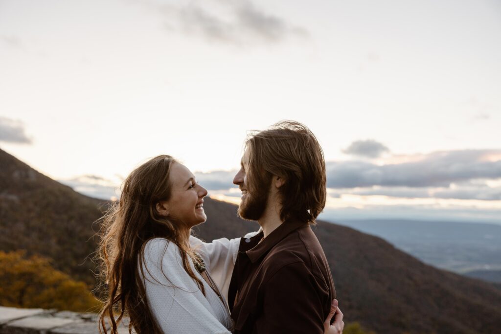 A couple smiles at one another during their elopement day in Virginia