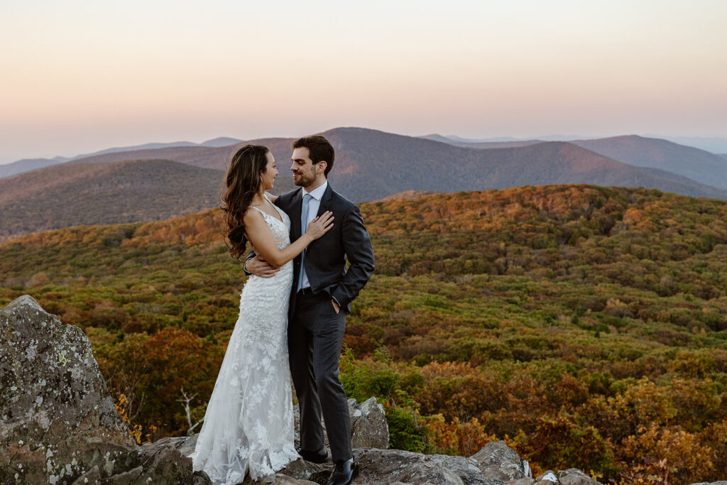 A bride and groom look at one another with love during their sunrise elopement. Shenandoah Fall Colors
