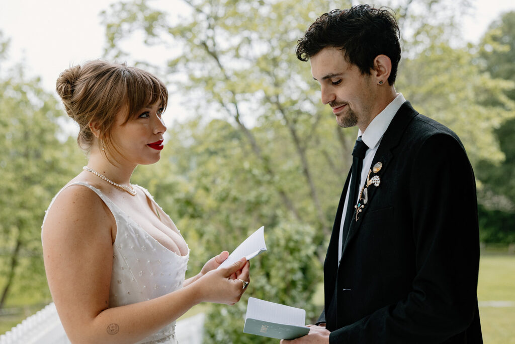 A birde reading her vows to her groom during their elopement.