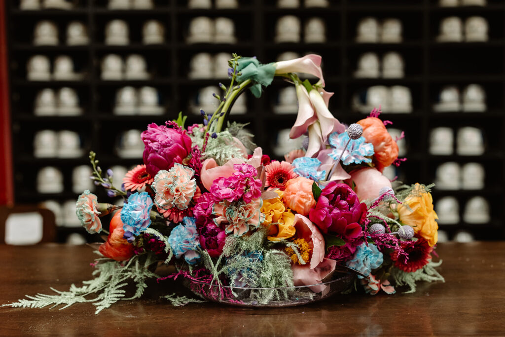 A bouquet of flowers that looks like a purse. It is full of colorful blooms. 