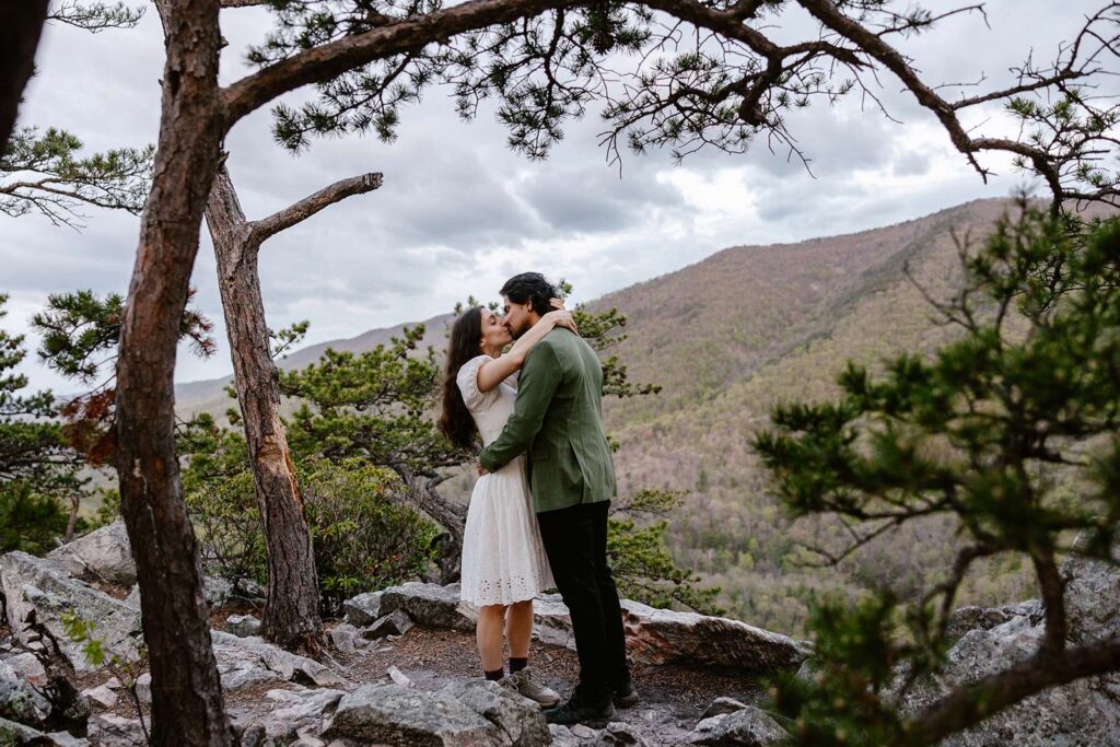 A bride and groom share their first kiss during their sunrise elopement at Buzzard Rock in Virginiia