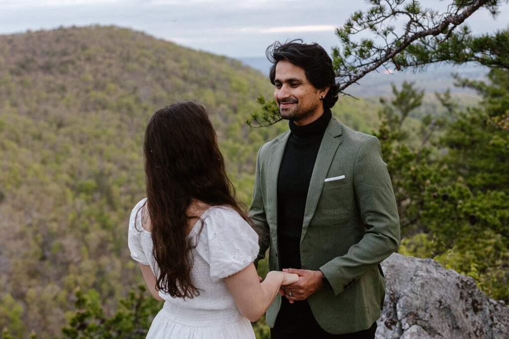 A groom exchanges vows with his bride during their sunrise elopement in Virginia