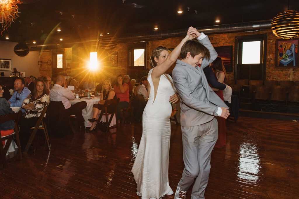 A bride spins her son during a dance on her wedding day