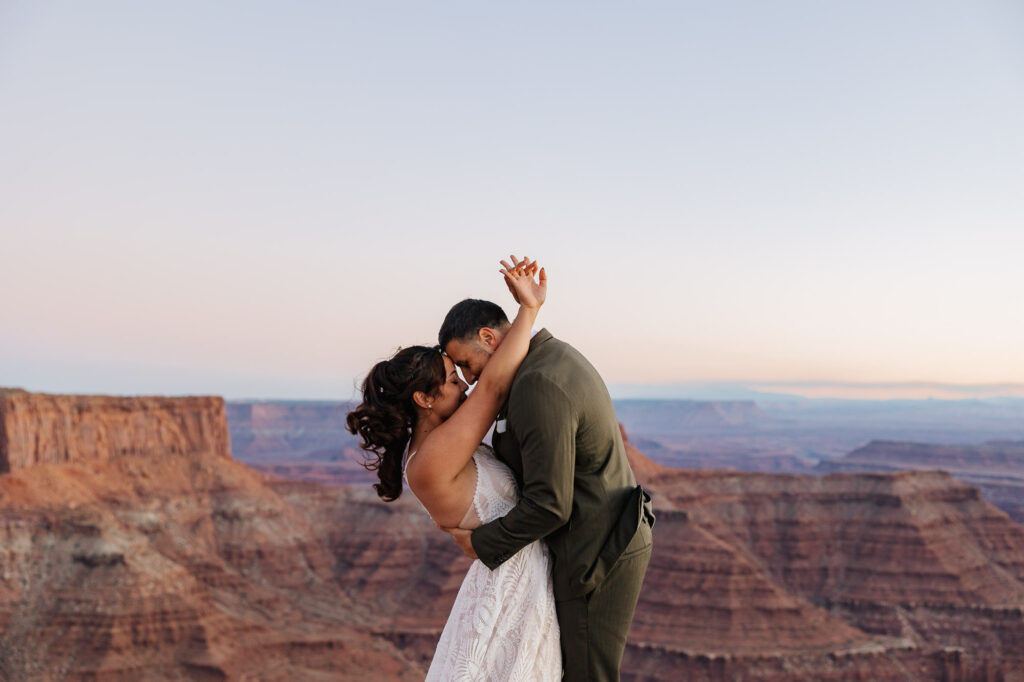A bride and groom share a sweet embrace during their adventure elopement as the sunsets